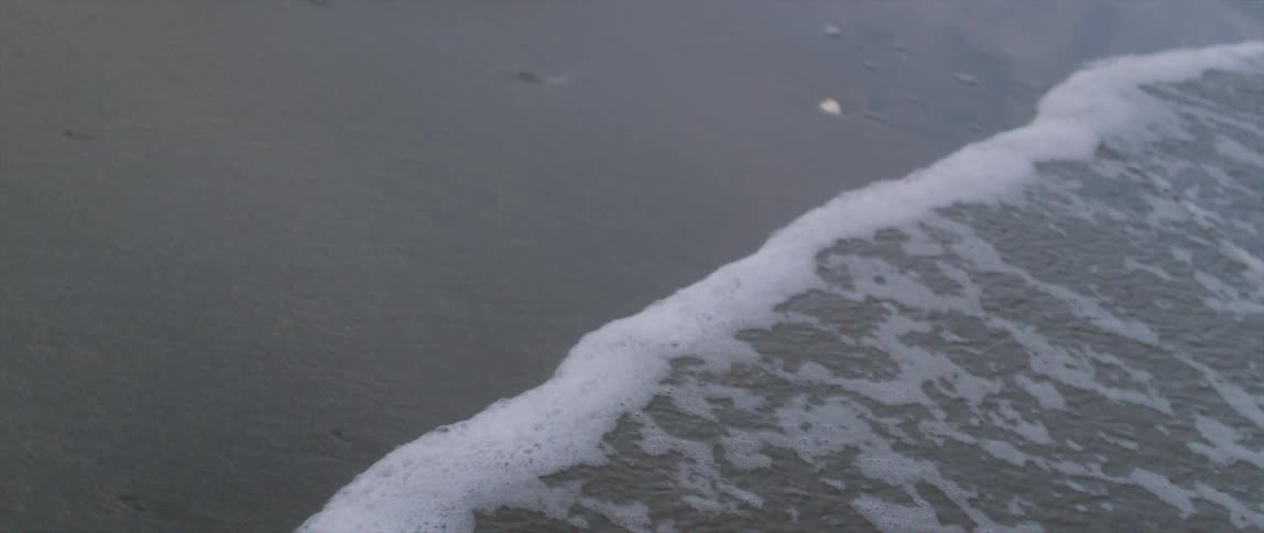 A beach with waves and sand