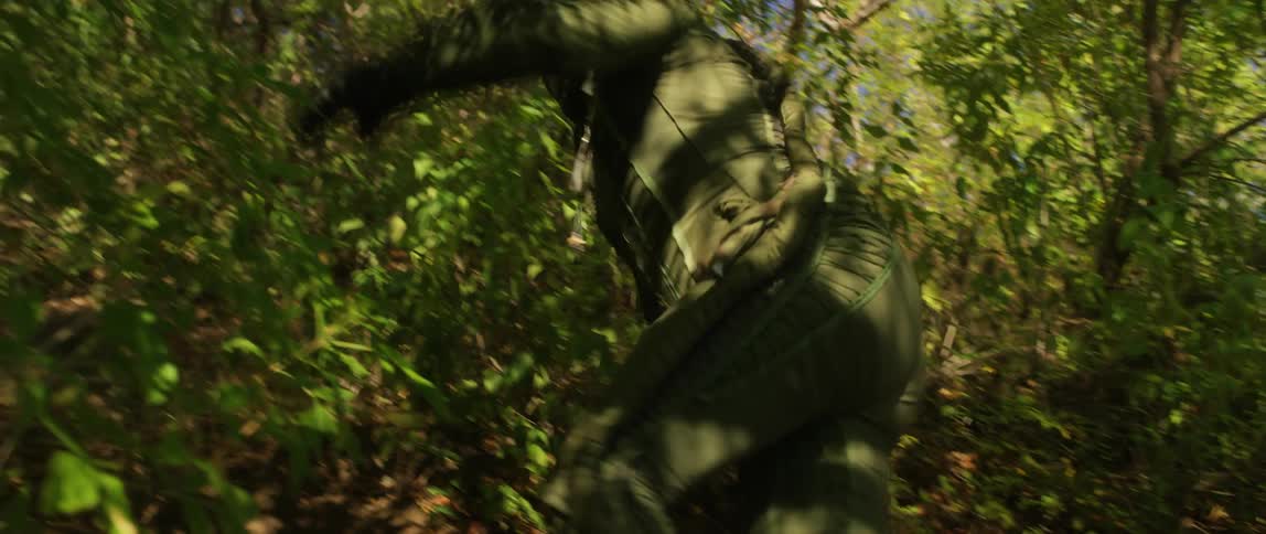 A person in a suit walking up a hill