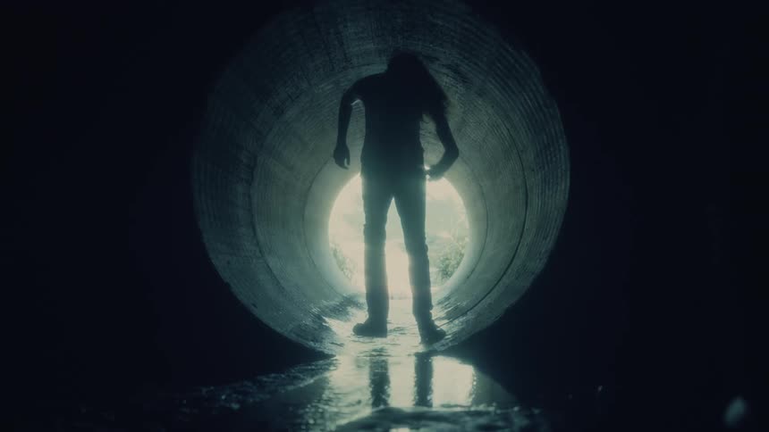 A view of a person walking down a tunnel