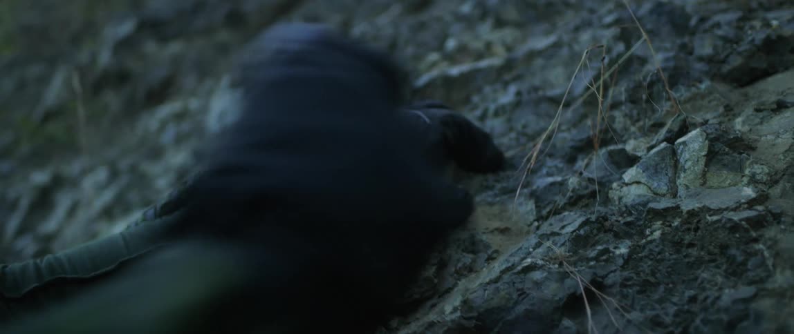 A person grips on to rock as they climb up