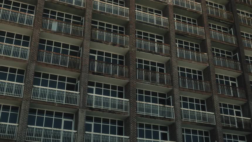 Rows of identical balconies on the facade of a building during the day