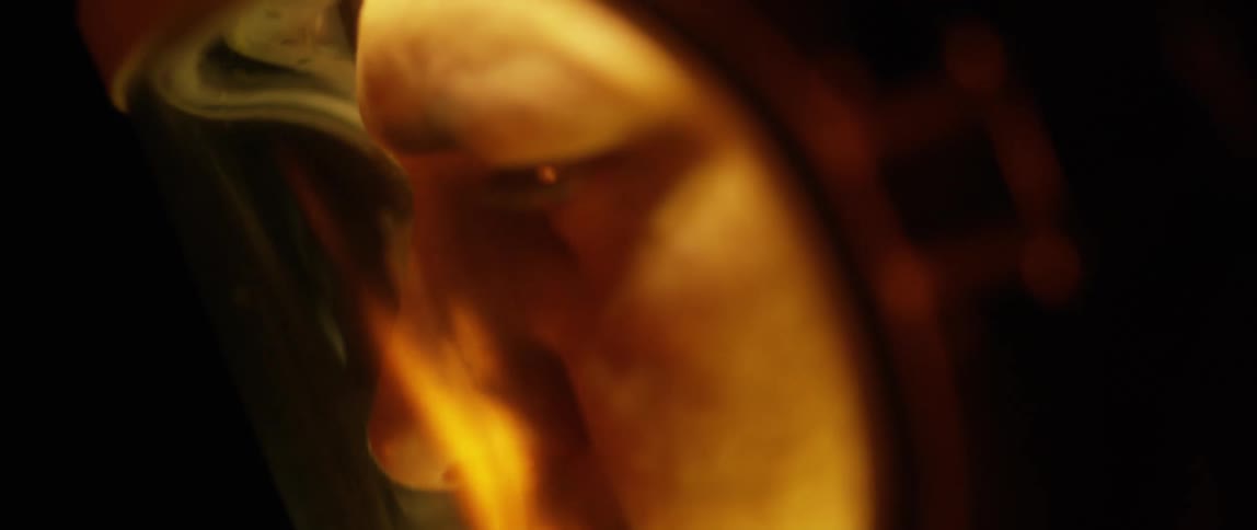 A burning fire reflected on a mans helmet