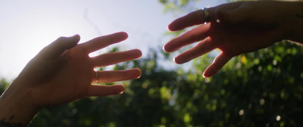 Two hands reaching towards each other with one then pulling away
