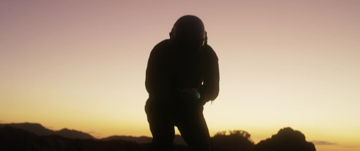 A man in a space suit getting up