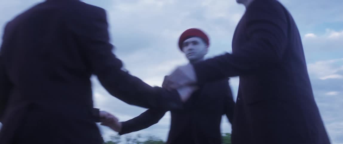 A group of men dancing in a circle outdoors