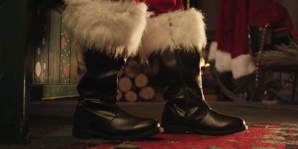 A person is wearing boots and standing indoors