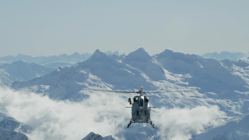Helicopter flying above mountain