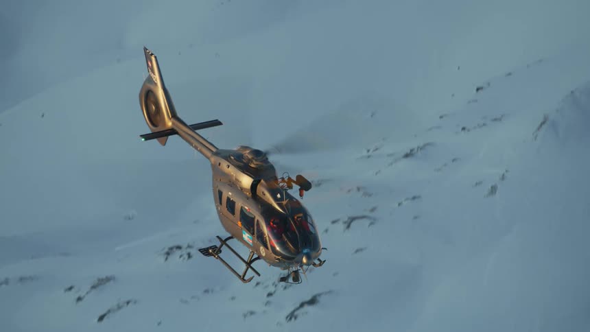 An aerial view of a helicopter above a mountain range