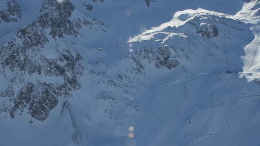 An aerial view of a mountain range covered in snow