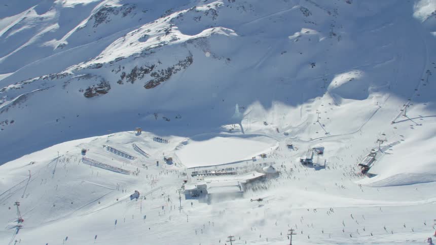 An aerial view of people skiing in a mountain area