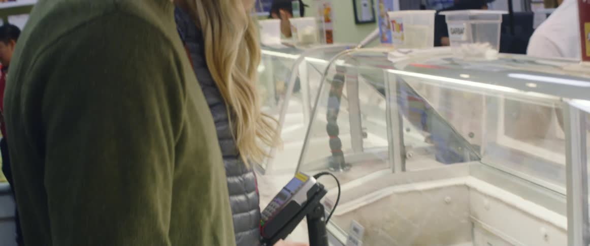 A man and woman sample ice cream
