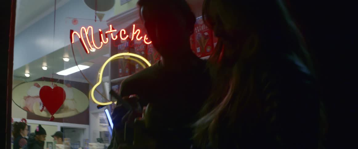 A man and woman outside a ice cream shop