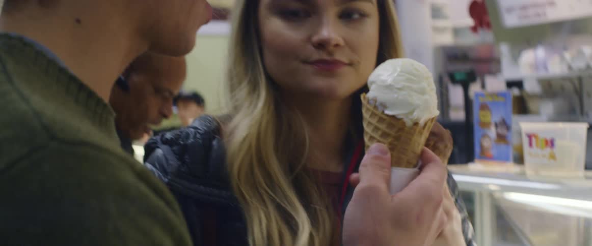 A couple make a toast with ice cream cones before eating them