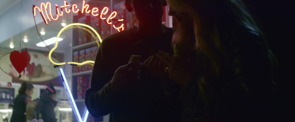 A man and woman outside a ice cream shop