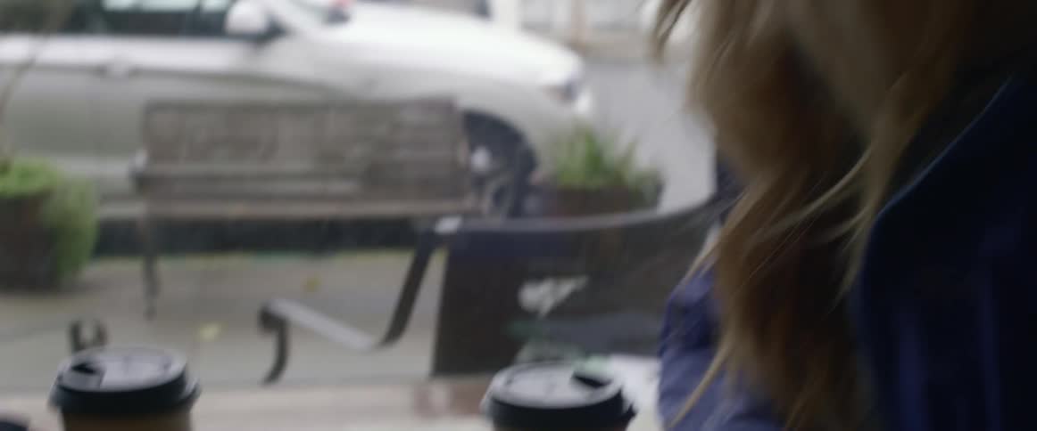 A woman talks and laughs at a table