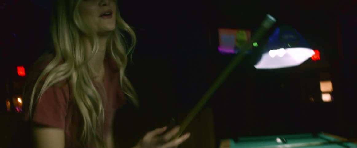 A woman shoots pool