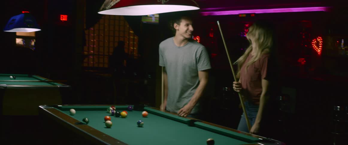 A man and woman playing pool