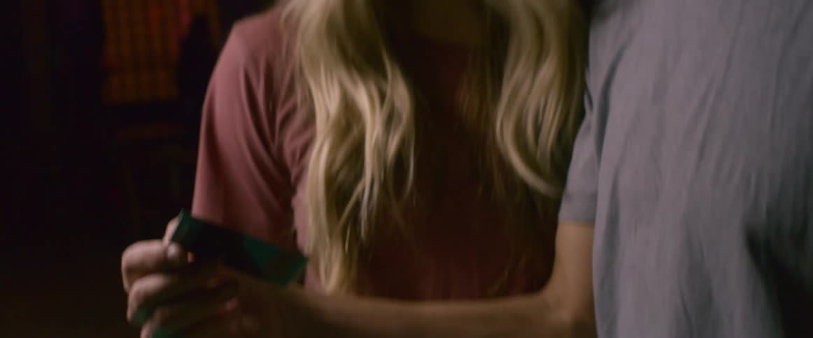 A photographer shows his work to his girlfriend
