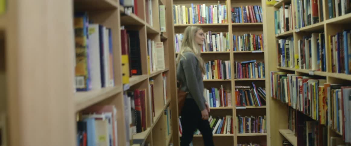 A couple walking through library stacks