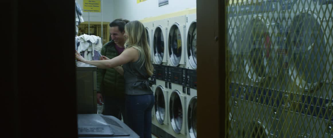 A man and women talk in a laundromat