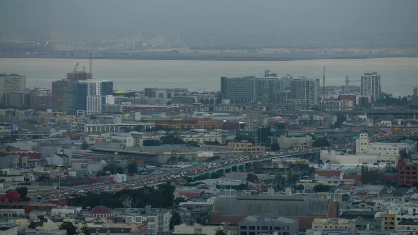 View of a busy city next to a body of water