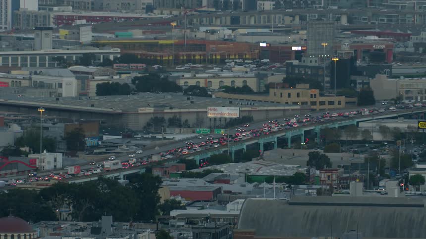 Cars navigate busy streets and freeways in an urban area