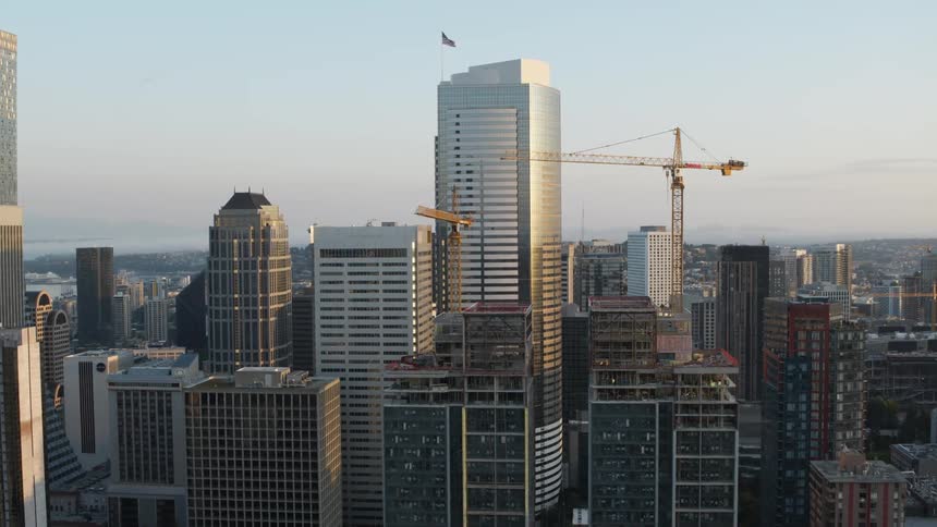 Subtle orbit around two skyscrapers under construction in a dense downtown area