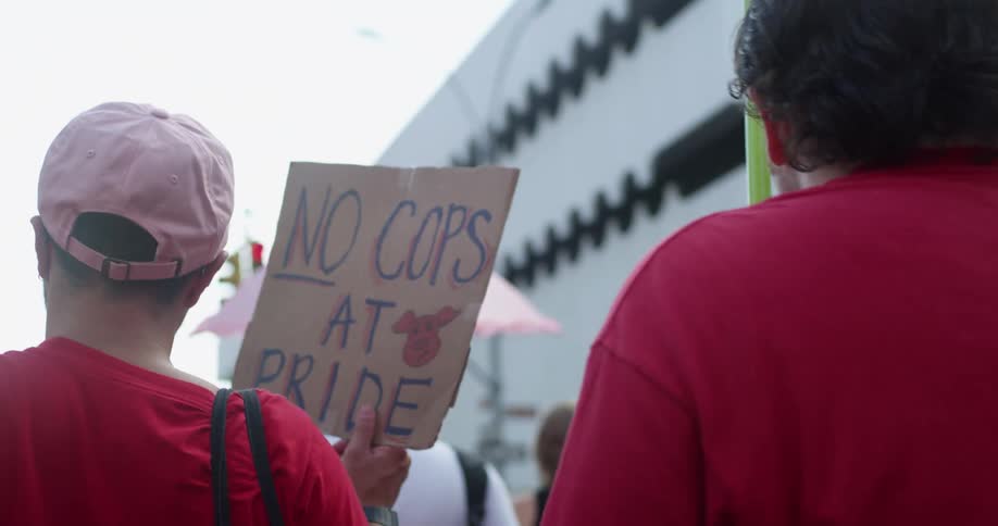 A group of protestors walking in the streets carrying signs