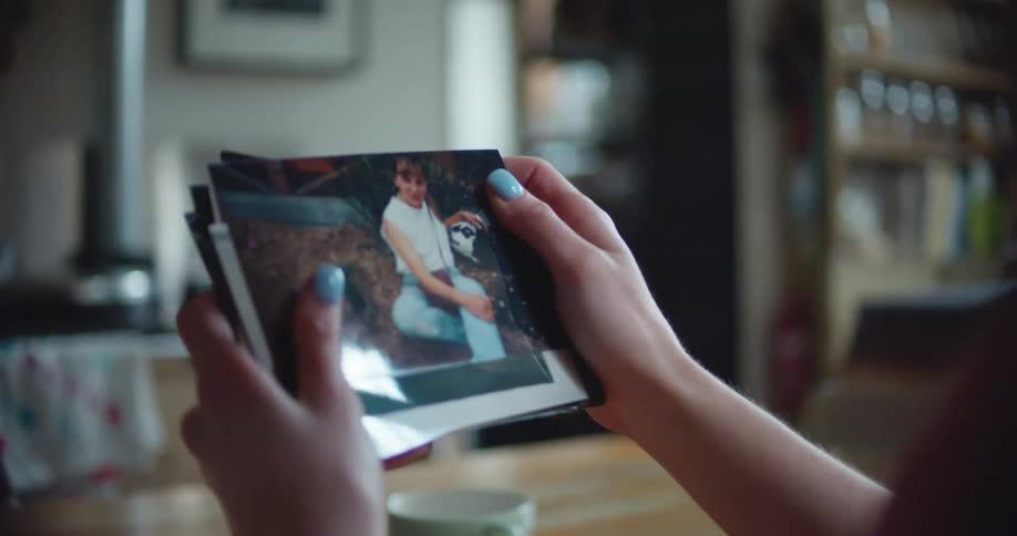 A woman looking at photos while sitting at a table
