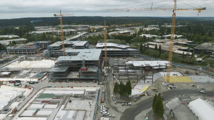 Wide orbit around the steel framework of multiple new office buildings being constructed