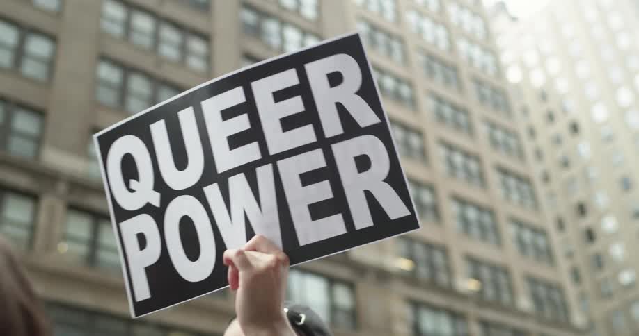 A man holds a sign supporting gay rights during a downtown protest