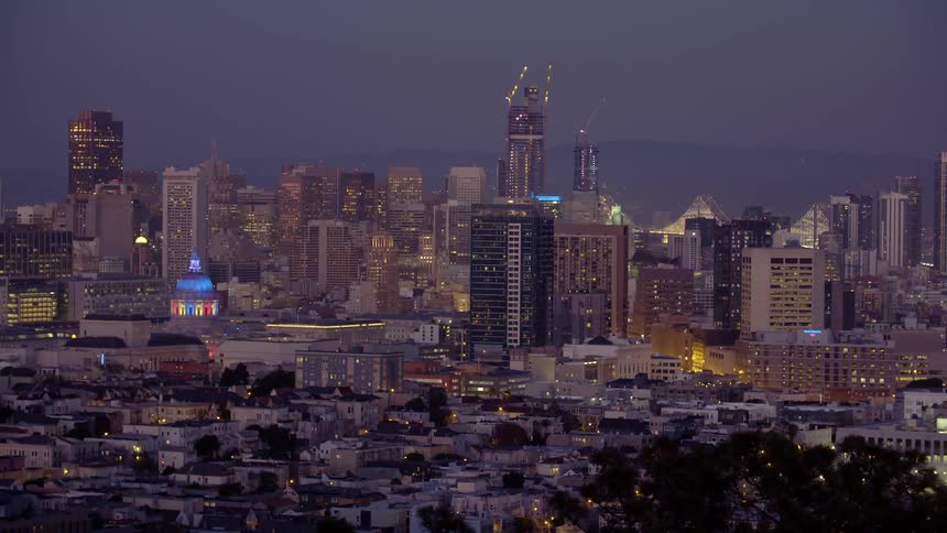A lit city sits at sunset
