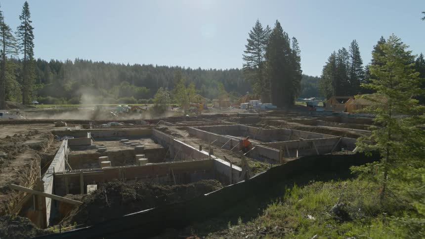 People and vehicles working on a brand new residential construction development