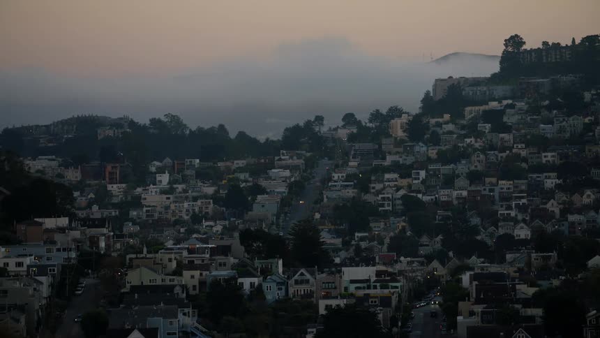 Time-lapse footage of a neighborhood located on a hillside as clouds pass overhead