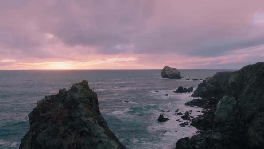 The ocean and its stormy clouds beat against the tall rocks we call cliffs only these look painful and slippery