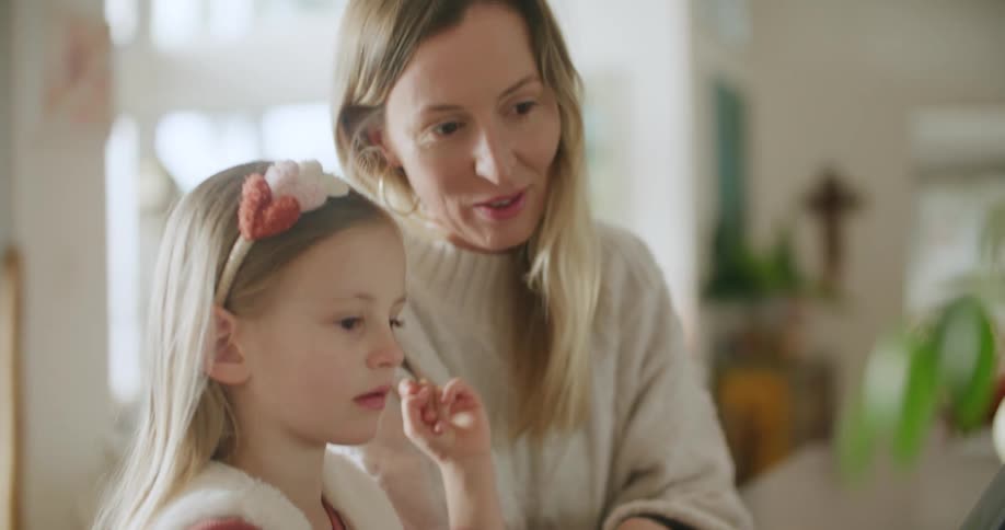 A mother and daughter playing with a tablet