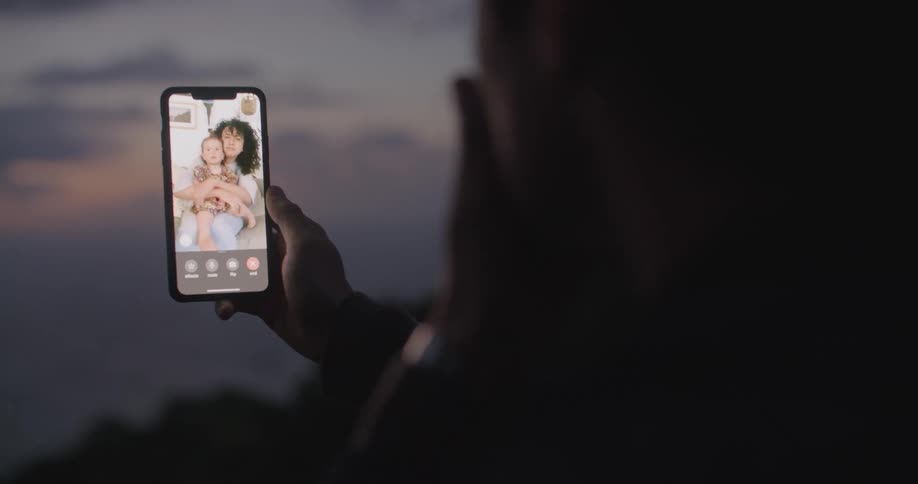 A person talking on a phone at dusk