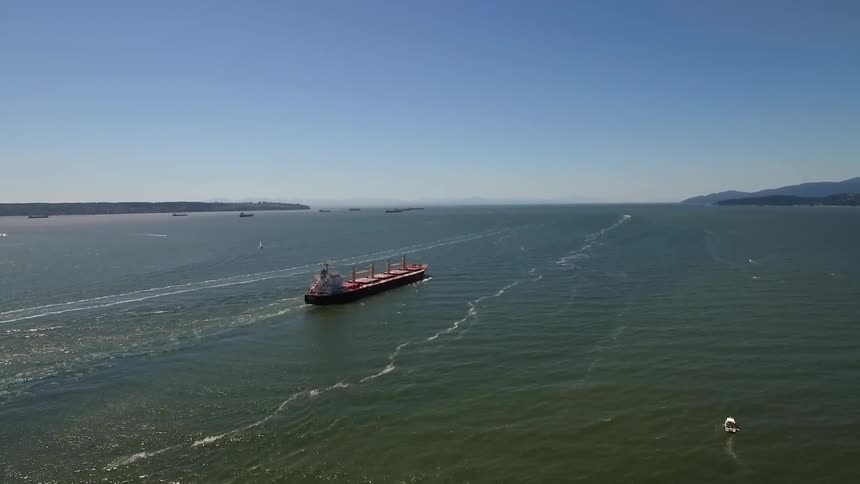 A large boat as it moves through a river during the day