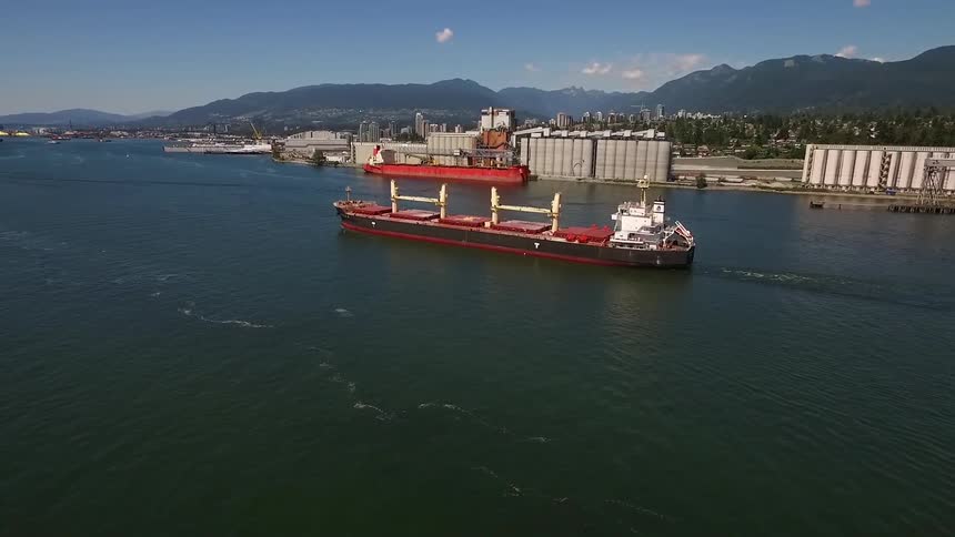 A large freight ship moves in the water