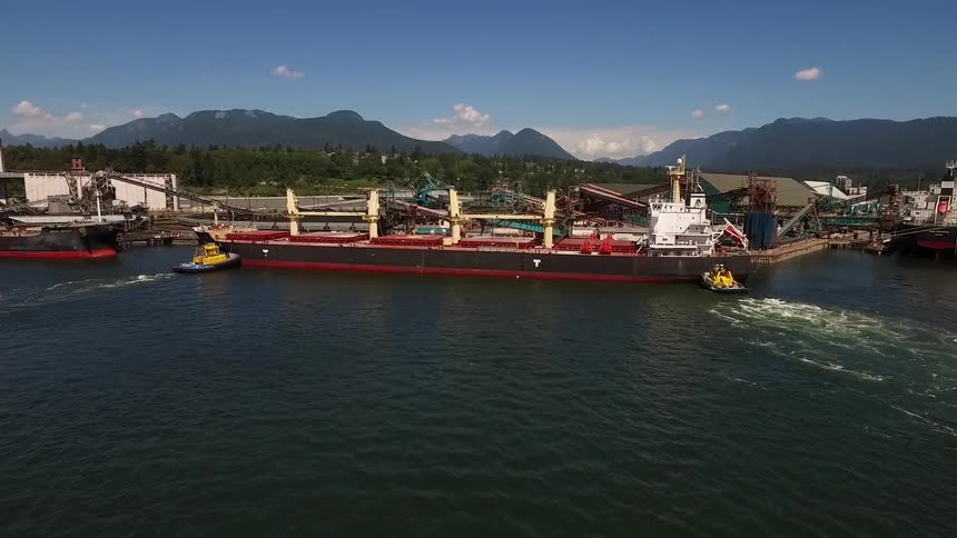 A large freight ship is sailing in the water
