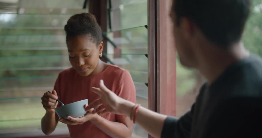 A man and woman talk as they eat