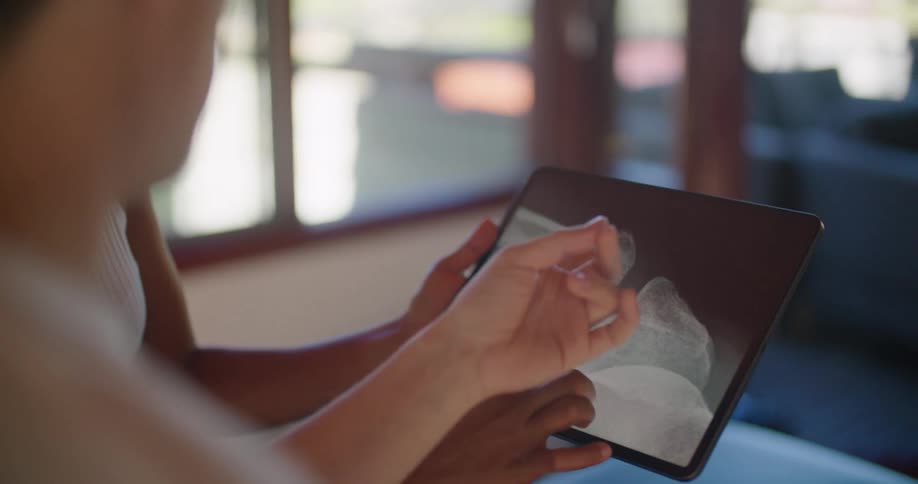 A view of someone looking at an a x ray on a tablet