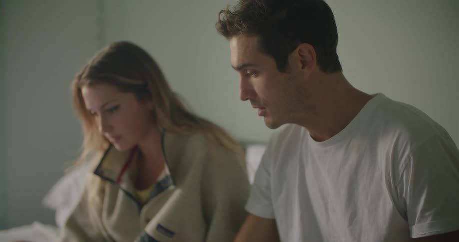 A man and woman sitting around together talking