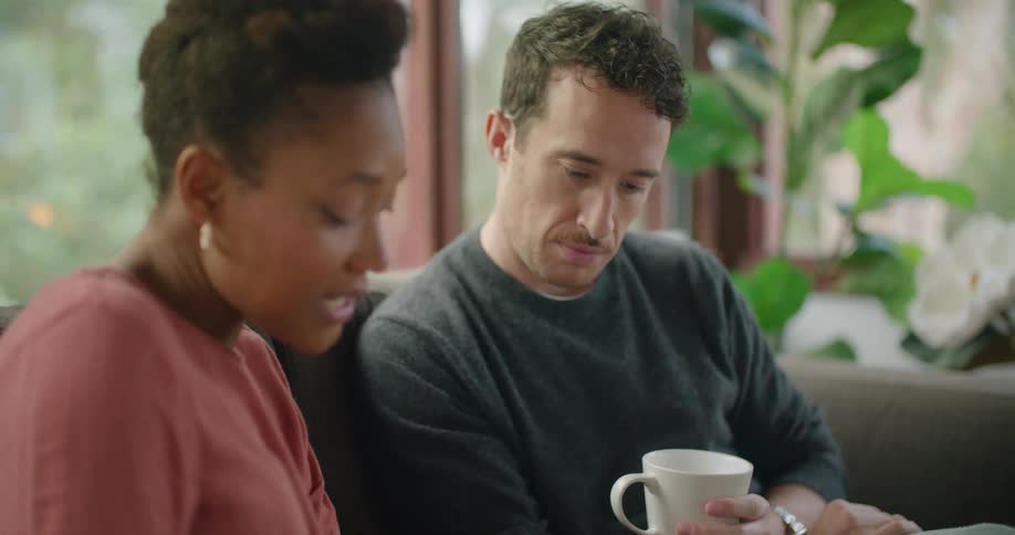 A man and woman looking at things and talking
