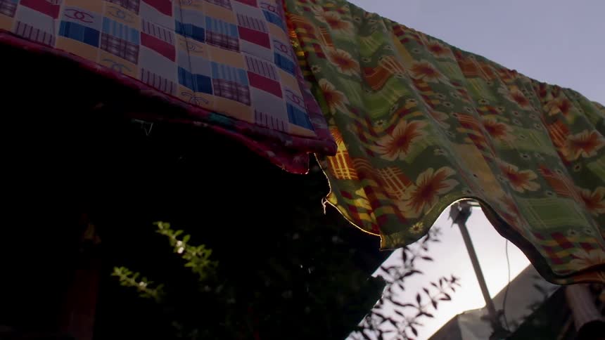 Blankets are hanging and dripping water