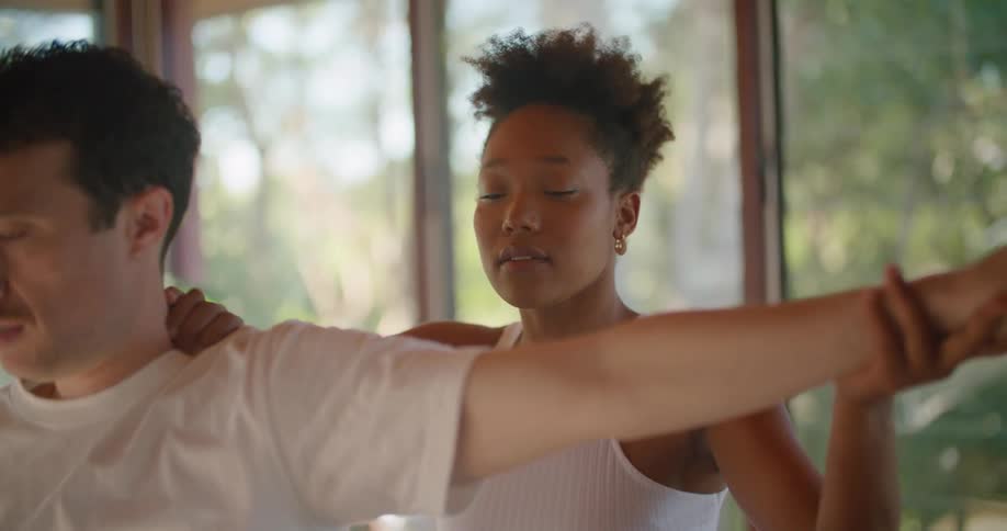 A man is receiving physical therapy from a woman