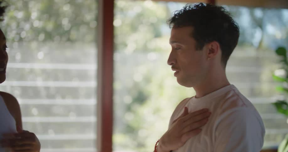 Woman teaching a man how to perform exercises at home