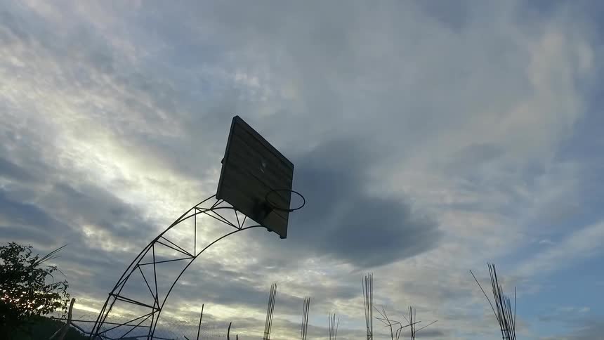 A basketball court sits empty on a cloudy day