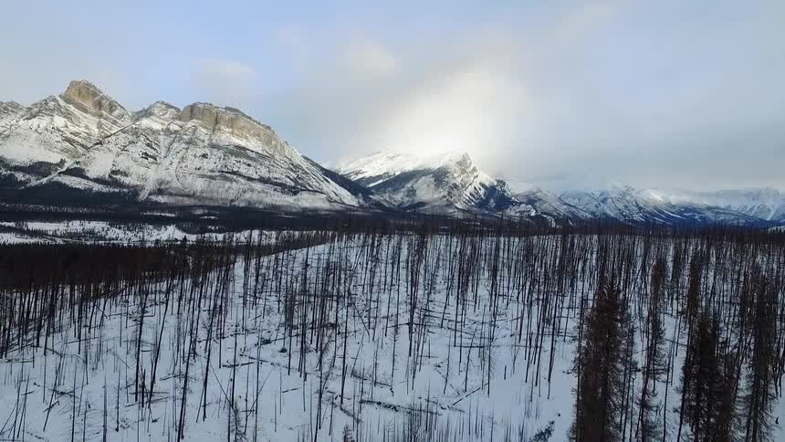 Moving over a snow covered field towards a mountain