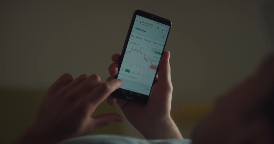 A person uses an app on his cell phone